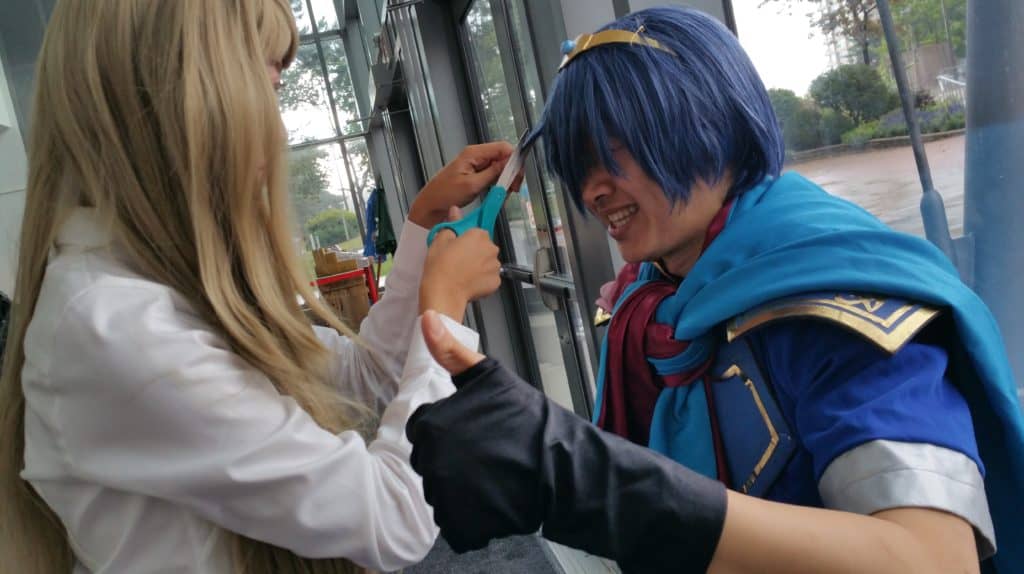 My friend helping me with my Marth before a shoot. Cosplay photoshoot